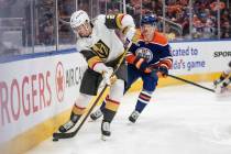 Vegas Golden Knights' Zach Whitecloud (2) is chased by Edmonton Oilers' Trent Frederic (21) dur ...