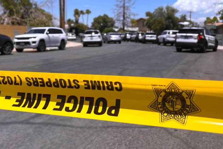 Police tape blocks the road while Metro investigates an officer involved shooting Tuesday, June ...