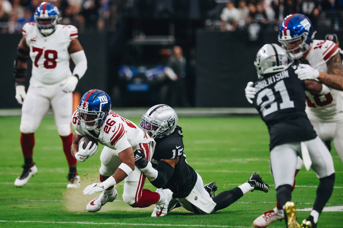 Raiders linebacker Jaylon Smith (15) smiles as he takes down New York Giants running back Saquo ...