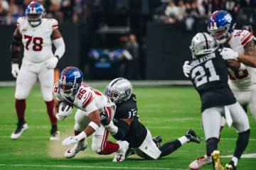 Raiders linebacker Jaylon Smith (15) smiles as he takes down New York Giants running back Saquo ...