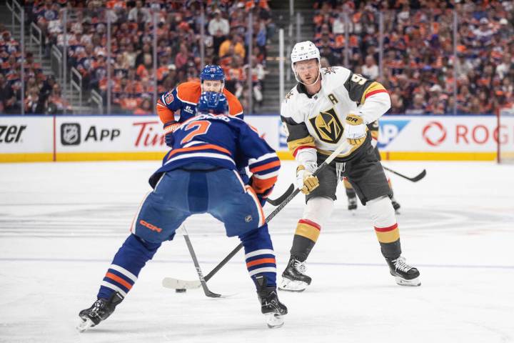 Vegas Golden Knights' Jack Eichel (9) tries to get past Edmonton Oilers' Evan Bouchard (2) duri ...
