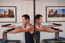 Charles Scott works out with resistance bands at home Thursday, May 1, 2025, in New York. (AP P ...