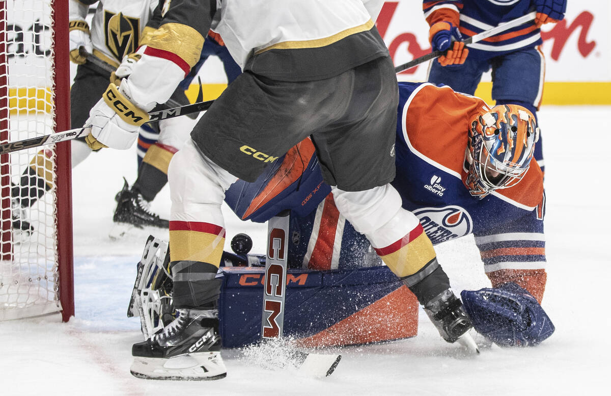 Edmonton Oilers goalie Stuart Skinner, bottom right, makes a save against the Vegas Golden Knig ...