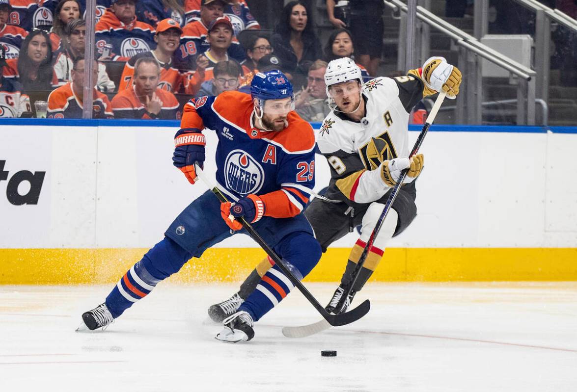 Vegas Golden Knights' Jack Eichel (9) and Edmonton Oilers' Leon Draisaitl (29) battle for the p ...