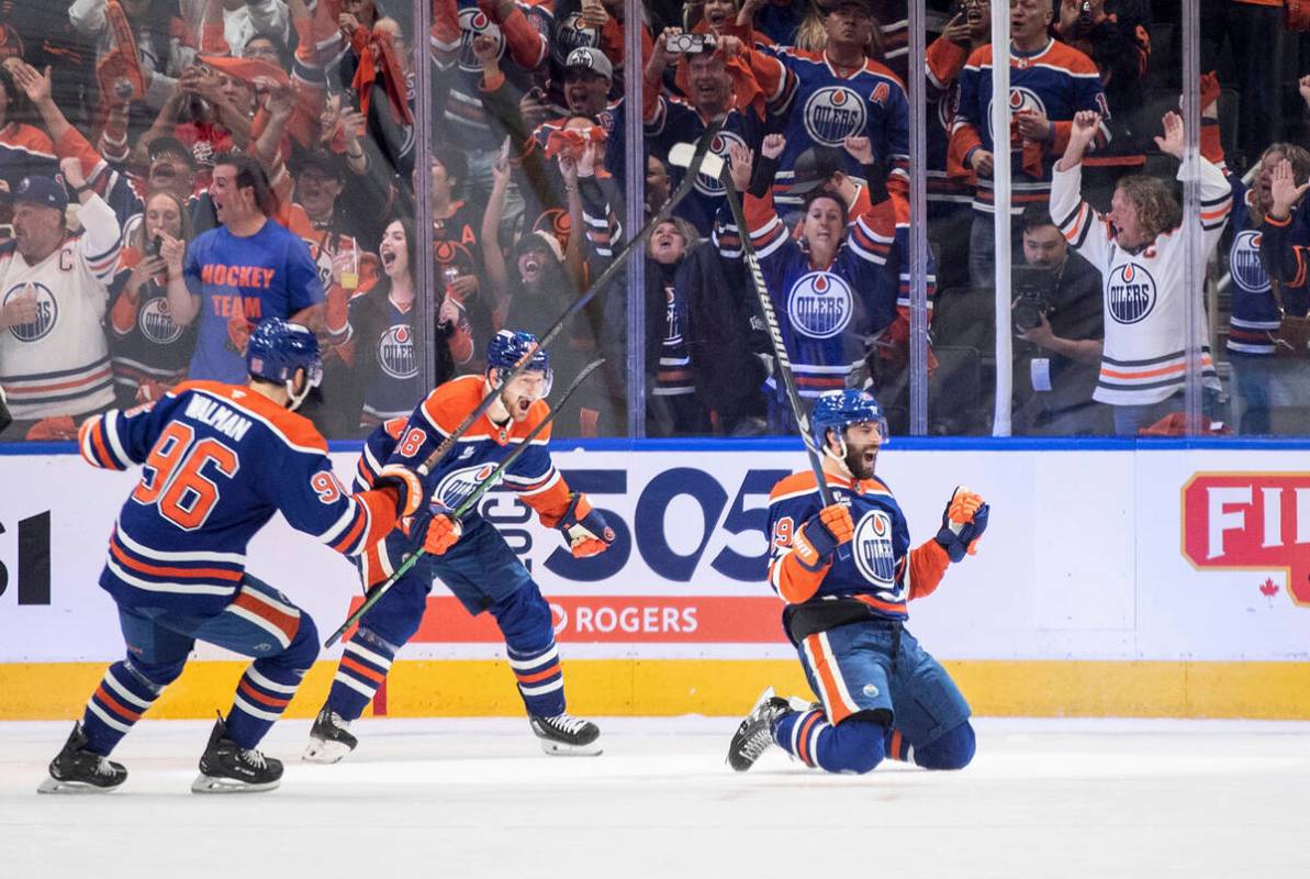 Edmonton Oilers' Adam Henrique (19), Jake Walman (96) and Zach Hyman (18) celebrate after a goa ...