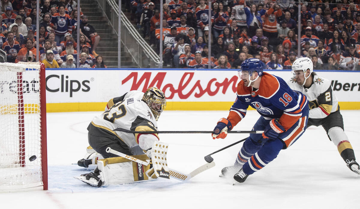 Vegas Golden Knights goalie Adin Hill (33) makes a save against Edmonton Oilers' Zach Hyman (18 ...