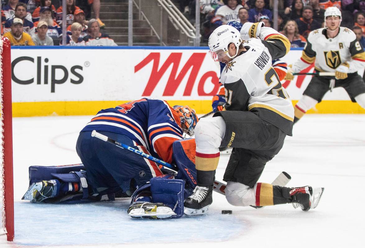 Vegas Golden Knights' Brett Howden (21) is stopped by Edmonton Oilers goalie Stuart Skinner (74 ...