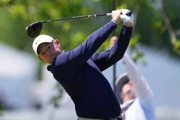 Rory McIlroy, of Northern Ireland, hits on the first hole during the third round of the Truist ...