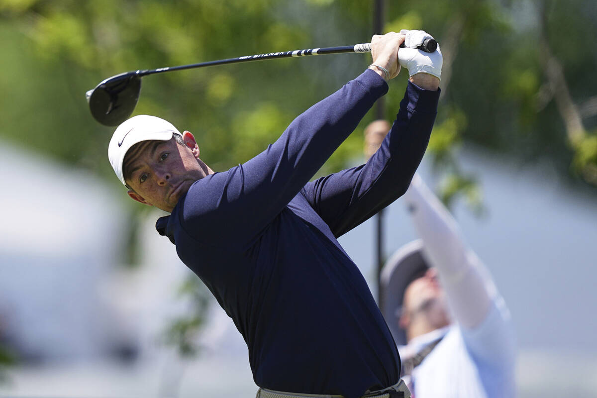 Rory McIlroy, of Northern Ireland, hits on the first hole during the third round of the Truist ...