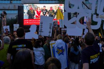 People watch a live broadcast of Israeli-American soldier Edan Alexander as he is released from ...