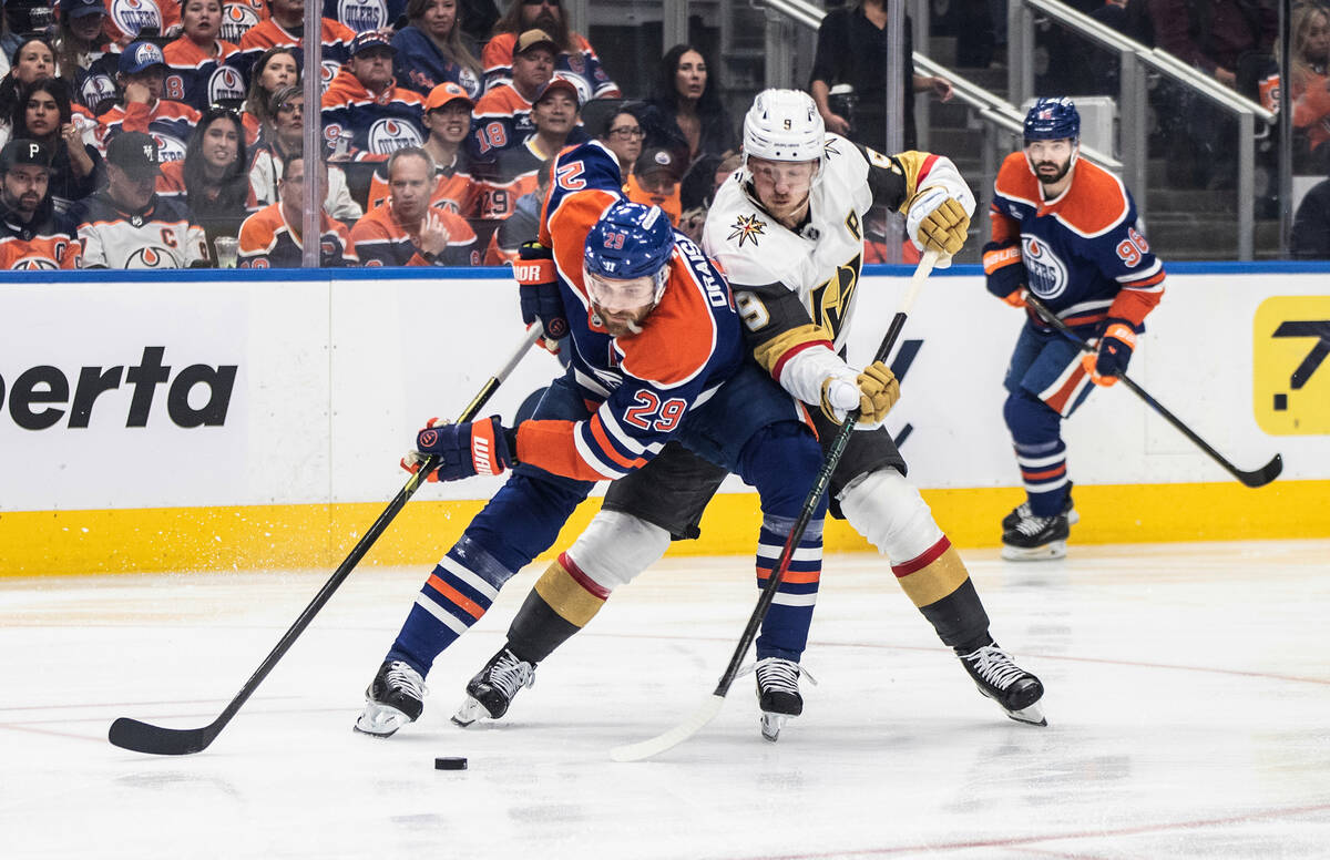 Vegas Golden Knights' Jack Eichel (9) and Edmonton Oilers' Leon Draisaitl (29) battle for the p ...