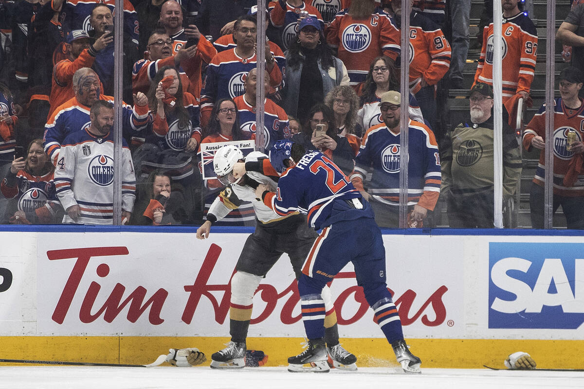 Vegas Golden Knights' Nicolas Hague (14) and Edmonton Oilers' Trent Frederic (21) fight during ...