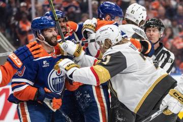 Vegas Golden Knights' William Karlsson (71) and Edmonton Oilers' Adam Henrique (19) scuffle dur ...