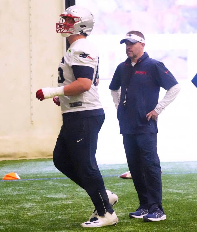 New England Patriots offensive coordinator Josh McDaniels, right, watches tackle Will Campbell ...
