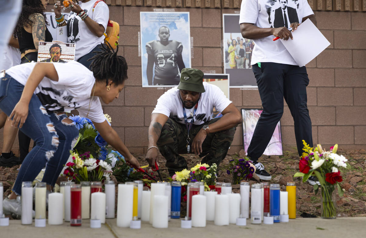 Justice Odabi lights candles in memory of his brother Joree Odabi during a vigil along Warm Spr ...
