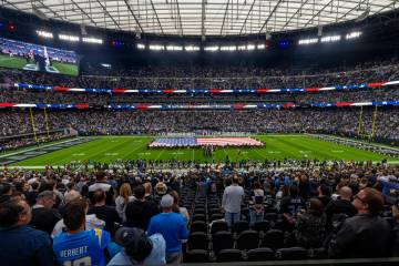 The flag is unfurled as the National Anthem is sung before the Raiders take on the Los Angeles ...