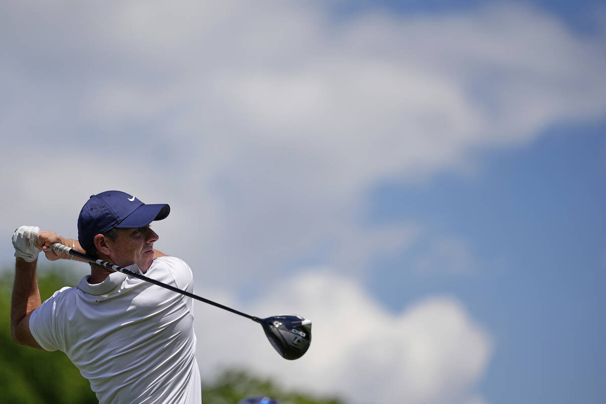 Rory McIlroy, of Northern Ireland, watches his tee shot on the first hole during a practice rou ...