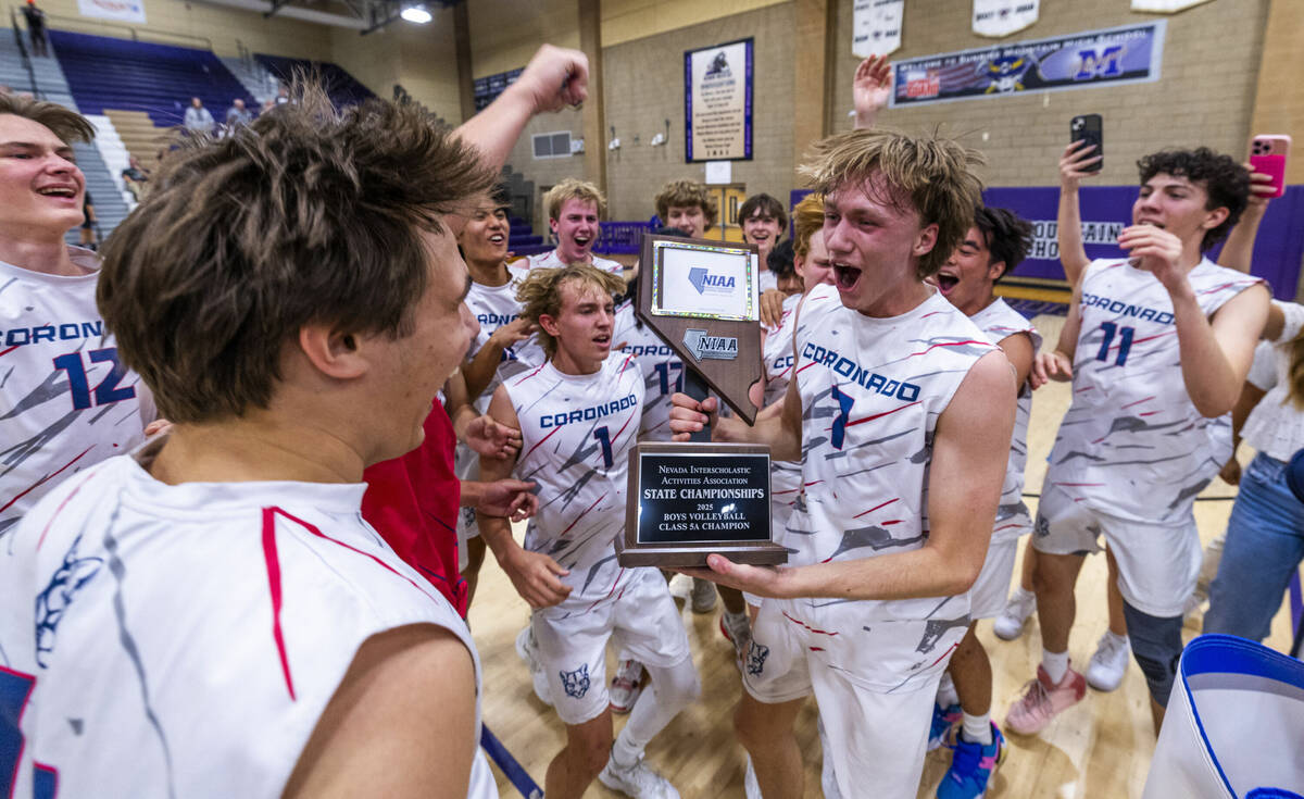 Coronado players celebrate with their trophy defeating Palo Verde to win the 5A boys volleyball ...