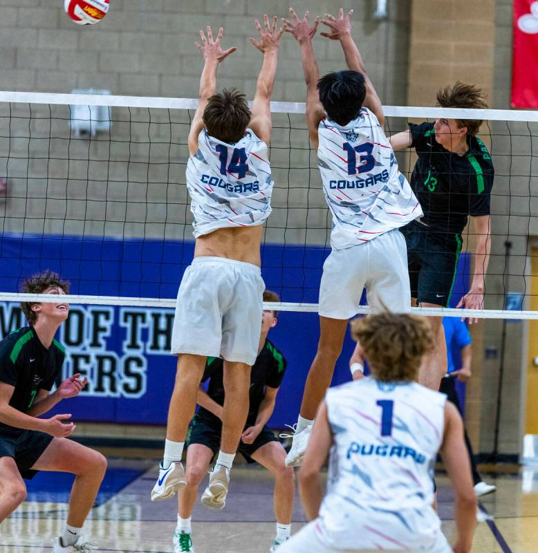 Coronado's Luke Wilkinson (14) and Treyden Baltazar (13) attempt to stop a spike over the net f ...