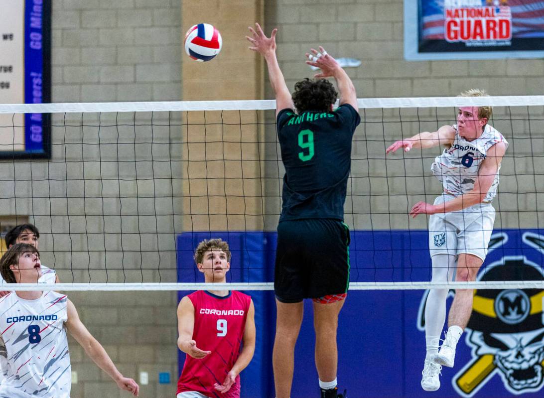 Coronado's Dexter Brimhall (6) spikes the ball past Palo Verde's Davide Bruce (9) as Deacon Men ...