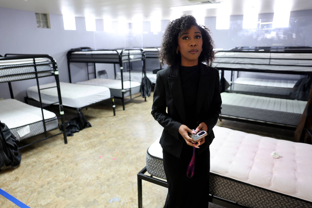 Director of Youth Programs and Family Services Tyra Mitchell shows the singles dormitory as ren ...