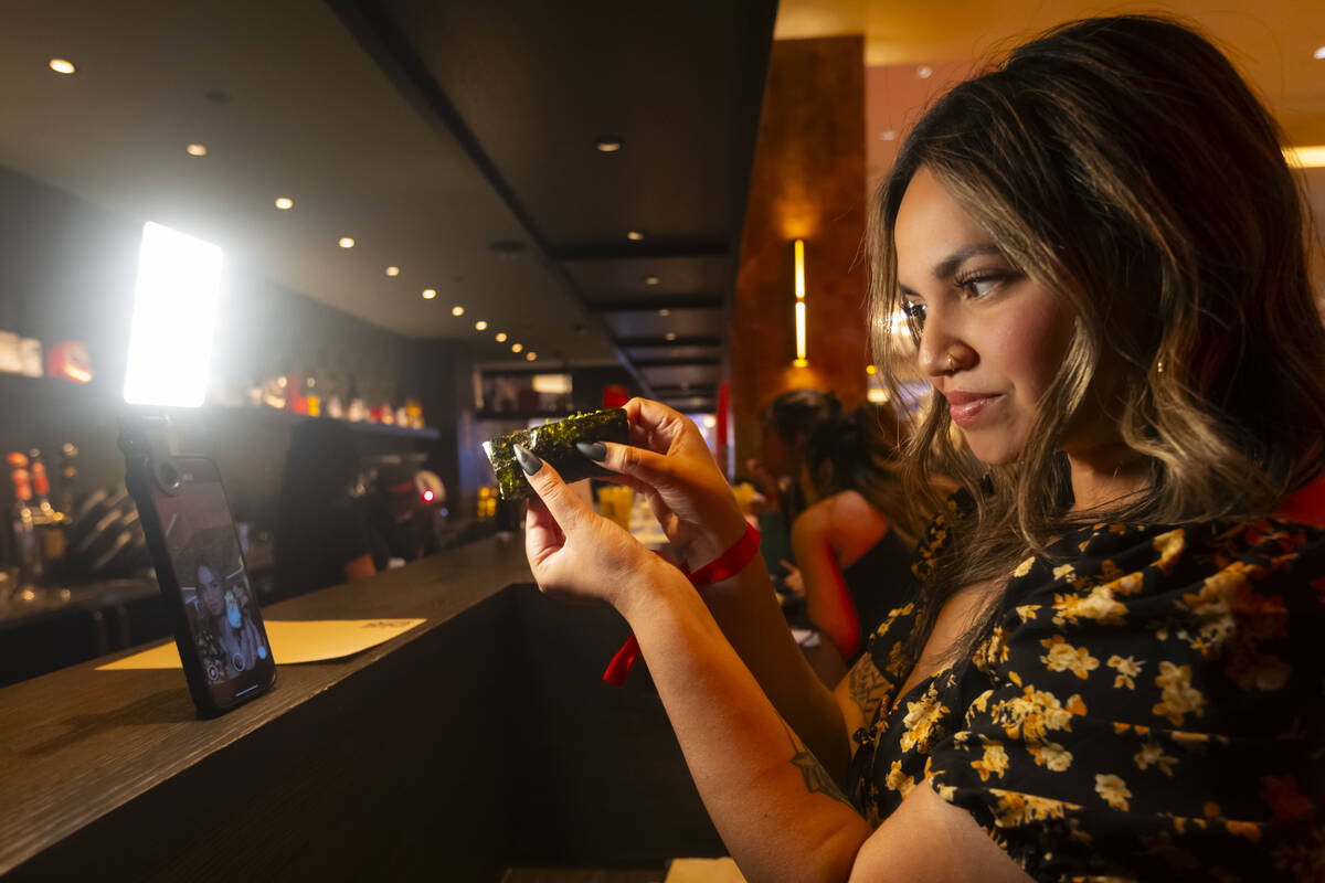 Influencer Giselle D'souza records content during the grand opening of Nomikai at The Venetian ...