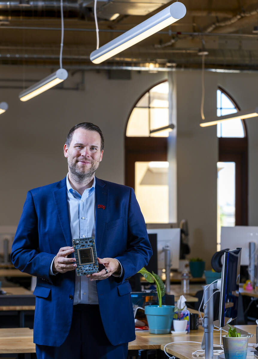 Piotr Tomasik as president of TensorWave holds one of their AMD GPU's, a graphics processing un ...