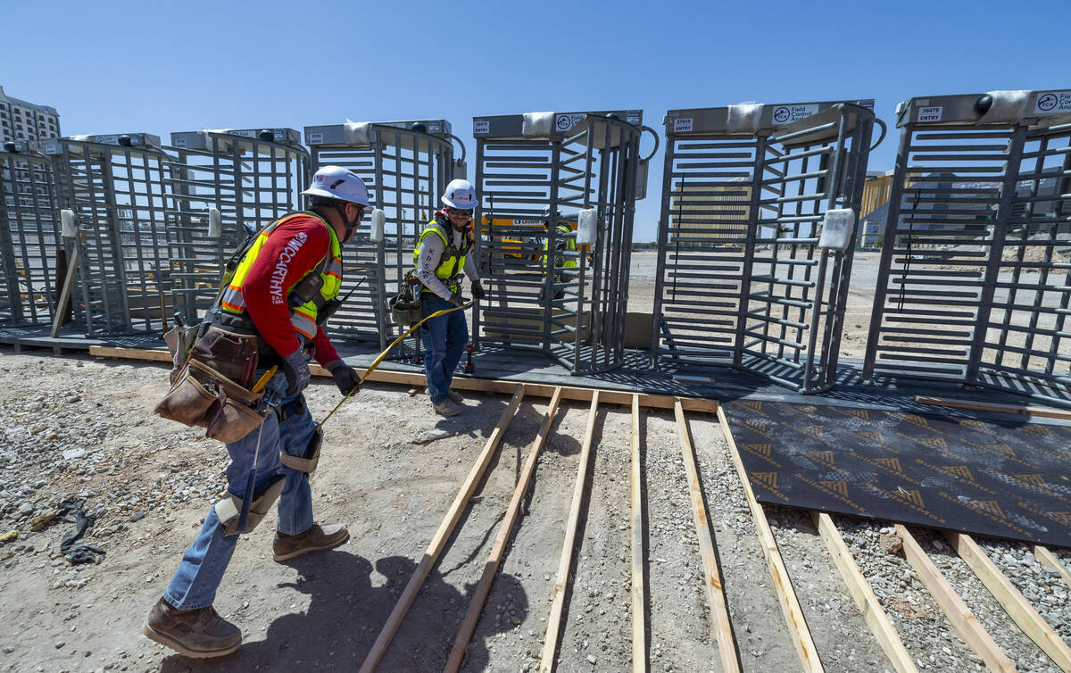 Turnstiles are installed as construction crews led by a venture of Mortenson and McCarthy Build ...