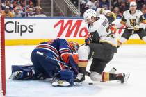 Vegas Golden Knights' Brett Howden (21) is stopped by Edmonton Oilers goalie Stuart Skinner (74 ...