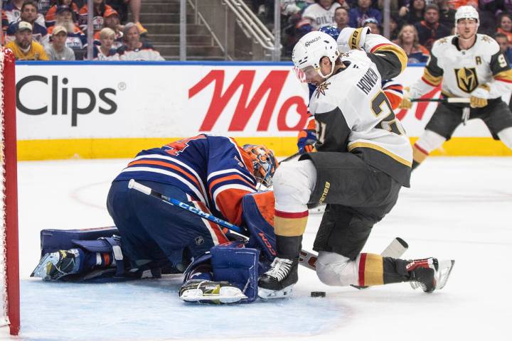 Vegas Golden Knights' Brett Howden (21) is stopped by Edmonton Oilers goalie Stuart Skinner (74 ...