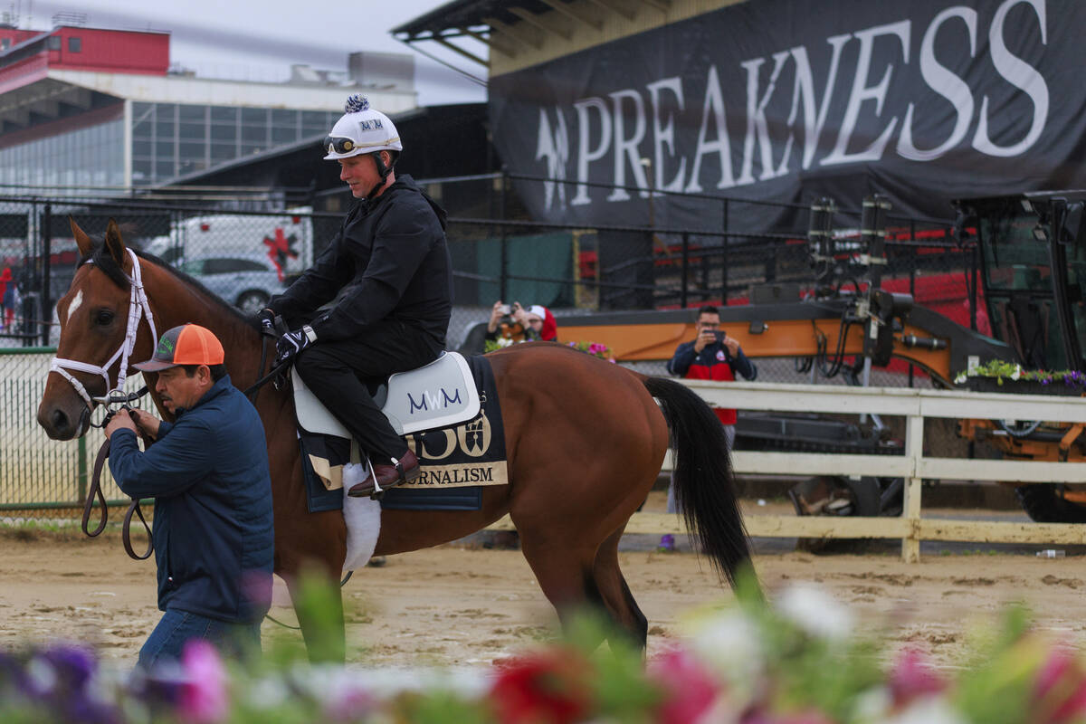 Journalism is led on the track at Pimlico Race Course in Baltimore, Wednesday, May 14, 2025, ah ...