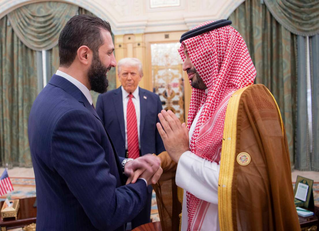 In this photo released by the Saudi Royal Palace, President Donald Trump, centre, looks to Saud ...