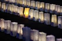 Candles flicker in paper bags during a vigil hosted by the Nevada Highway Patrol to honor traff ...