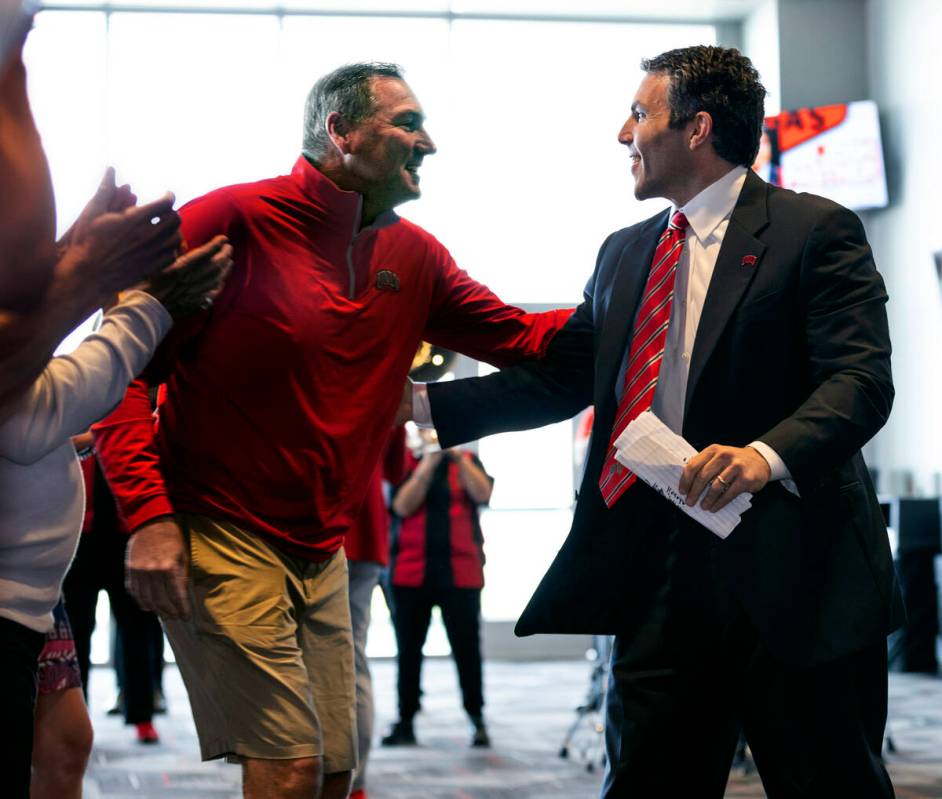 New UNLV men's basketball coach Josh Pastner greets head football coach Dan Mullen at an introd ...