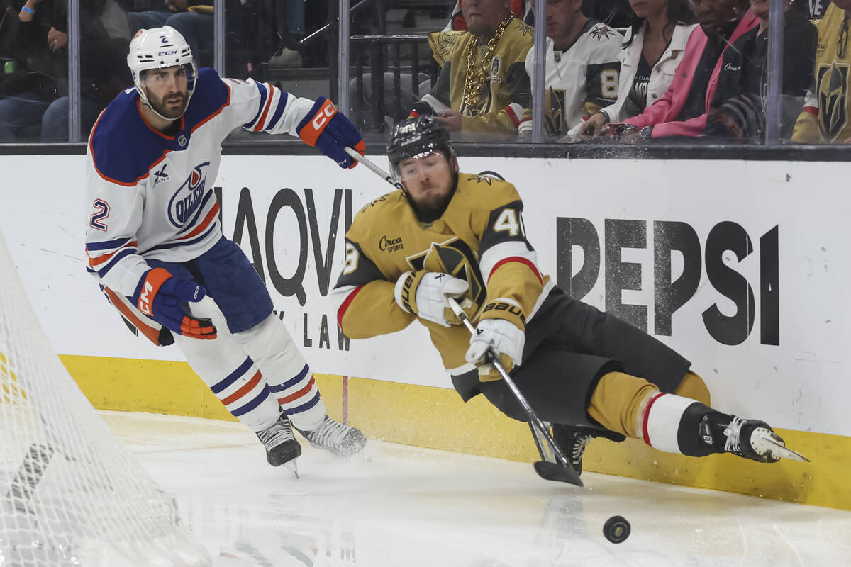 Golden Knights center Ivan Barbashev (49) gets tripped by Edmonton Oilers defenseman Evan Bouch ...