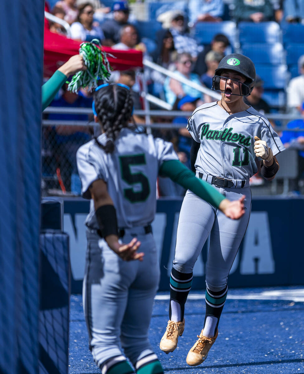 Palo Verde batter Taylor Johns (11) celebrates a score with teammate Ava Cruz (5) and others ag ...