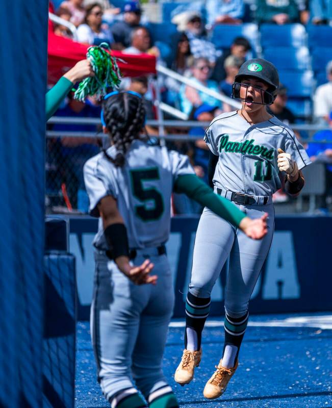 Palo Verde batter Taylor Johns (11) celebrates a score with teammate Ava Cruz (5) and others ag ...