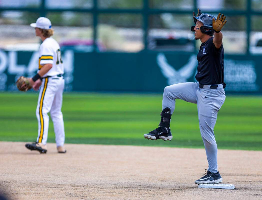 Faith Lutheran runner Rouselle Shepard (5) celebrates a double against Bishop Manogue during da ...
