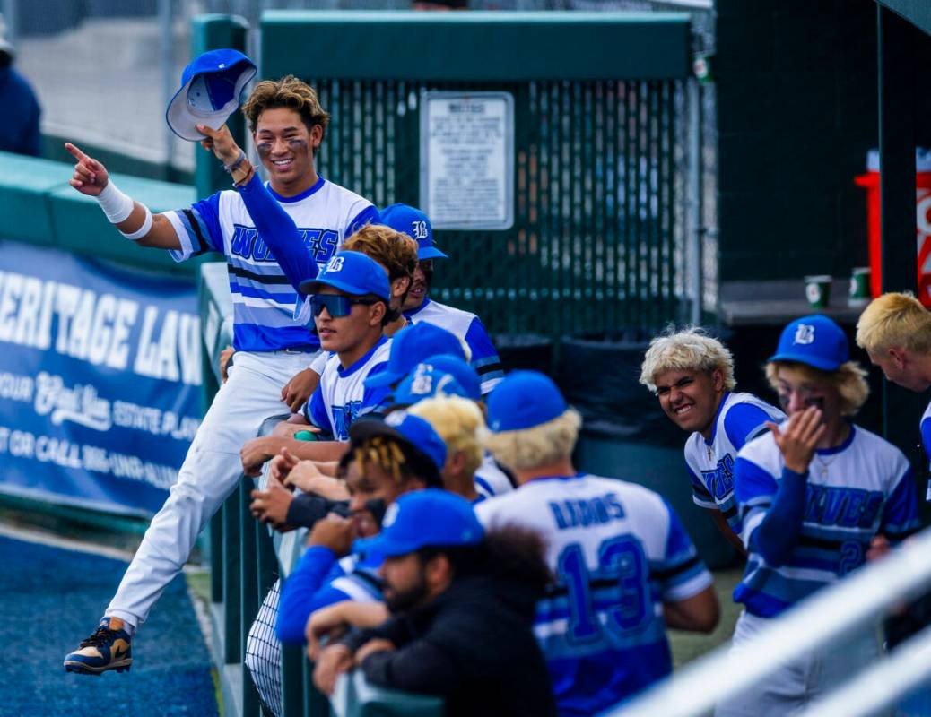 Basic players in the dugout celebrate another hit against Reno during day one of the 5A basebal ...