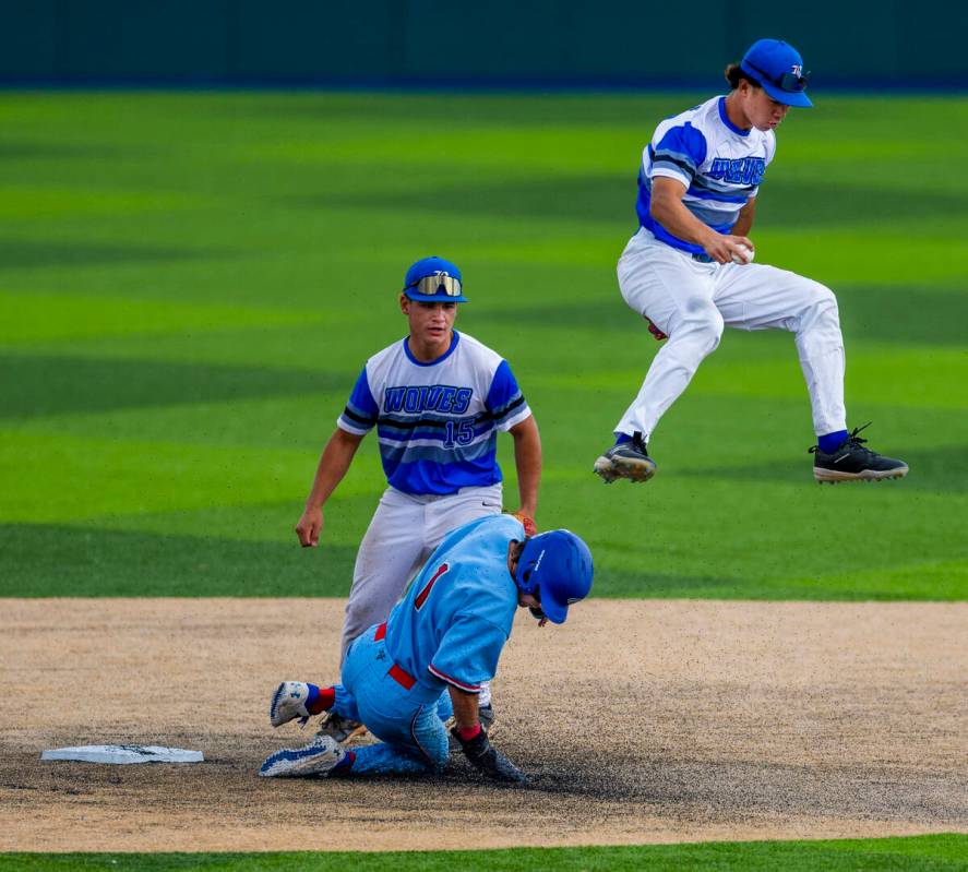 Basic infielder Tate Southisene (8) tags second base then leaps over Reno runner Jackson Berg ( ...
