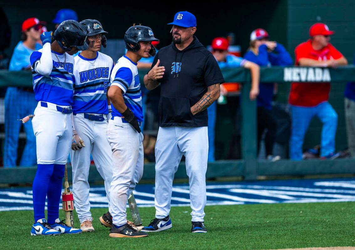 Basic players gather with a coach on a timeout against Reno during day one of the 5A baseball s ...