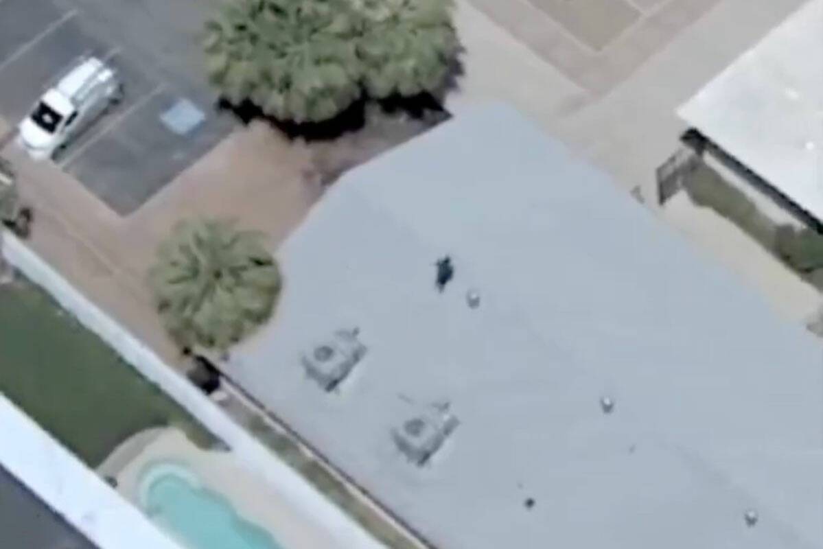 A man runs away from Las Vegas police officers after a high speed chase on Tuesday, May 13, 202 ...