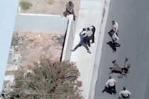 A man runs away from Las Vegas police officers after a high speed chase on Tuesday, May 13, 202 ...