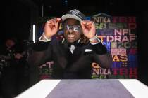 Boise State running back Ashton Jeanty puts on a hat after being chosen by the Las Vegas Raider ...