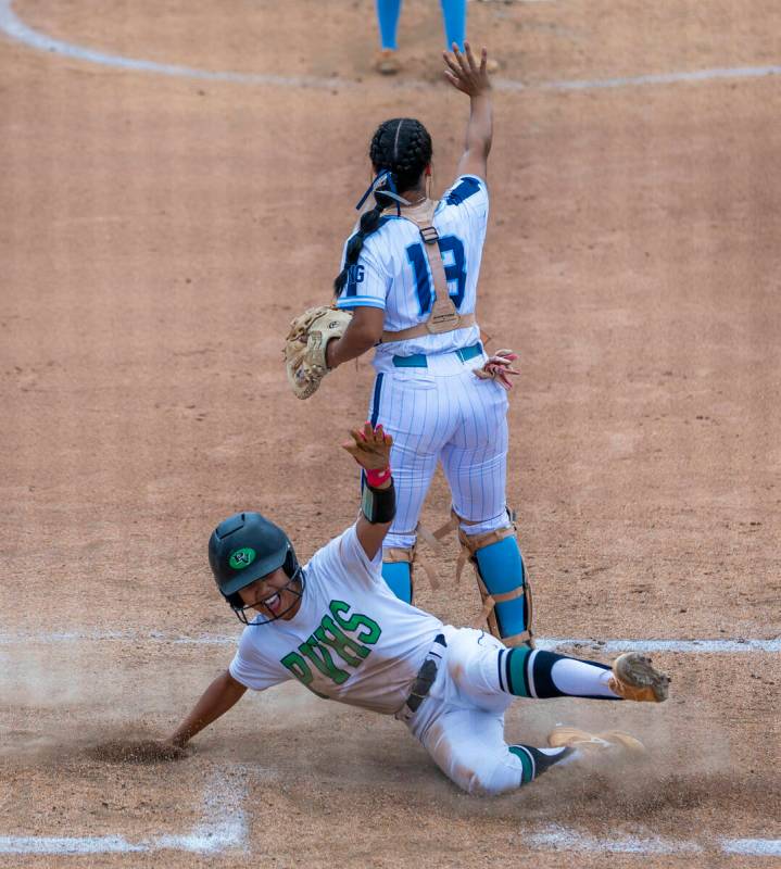 Palo Verde runner Makayla Enriquez (17) slides home safely for a run as Centennial catcher Aman ...