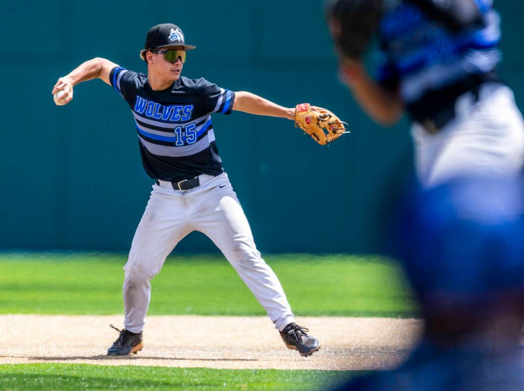 Basic infielder Lyndon Lee (15) throws the ball to first base against Faith Lutheran batter dur ...