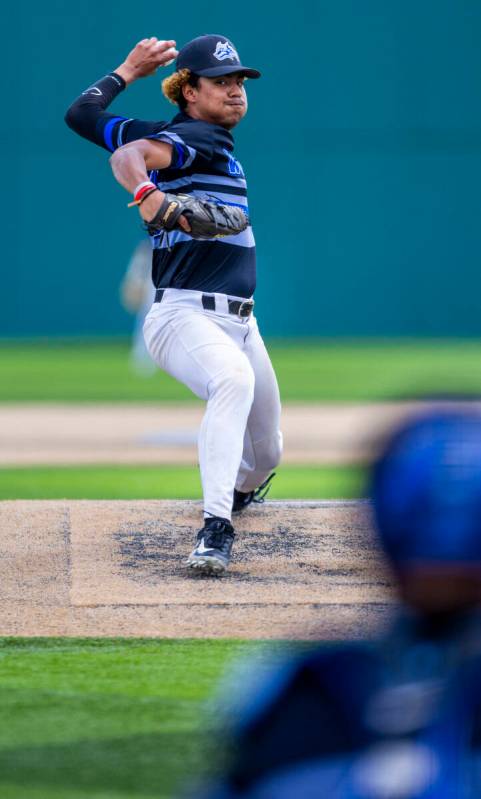 Basic pitcher Elian Ruiz (40) winds up another throw to home and a Faith Lutheran batter during ...