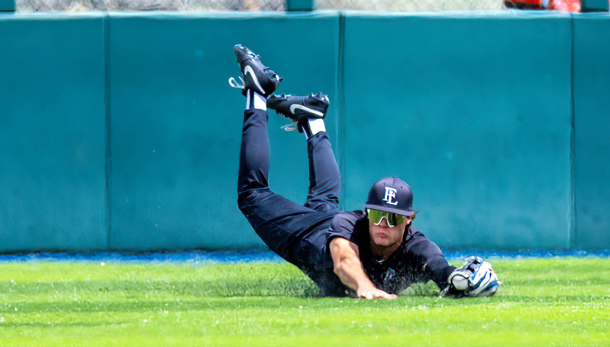 Faith Lutheran outfielder Ace Hansen (1) makes a diving catch against a Basic batter during day ...