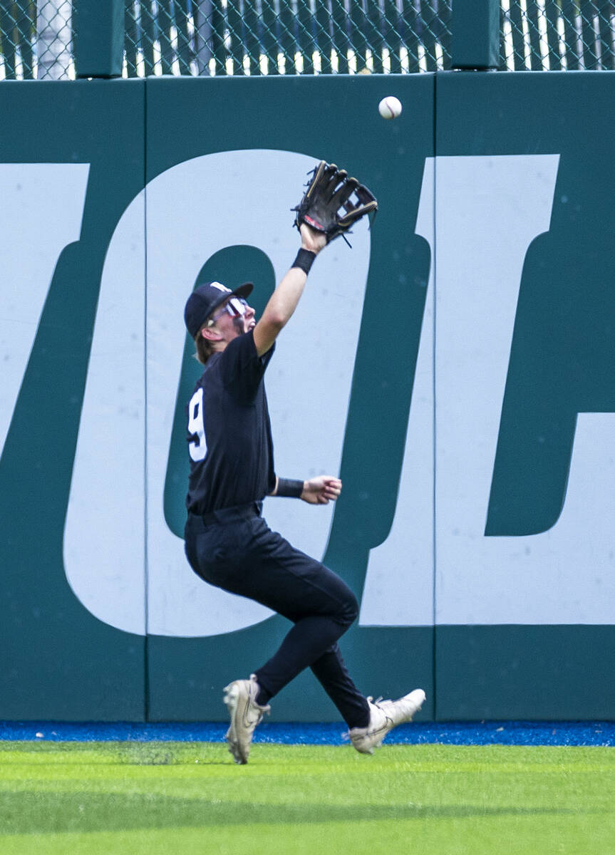 Faith Lutheran outfielder Nate Keyes (9) goes deep to catch a long fly ball from Basic during d ...