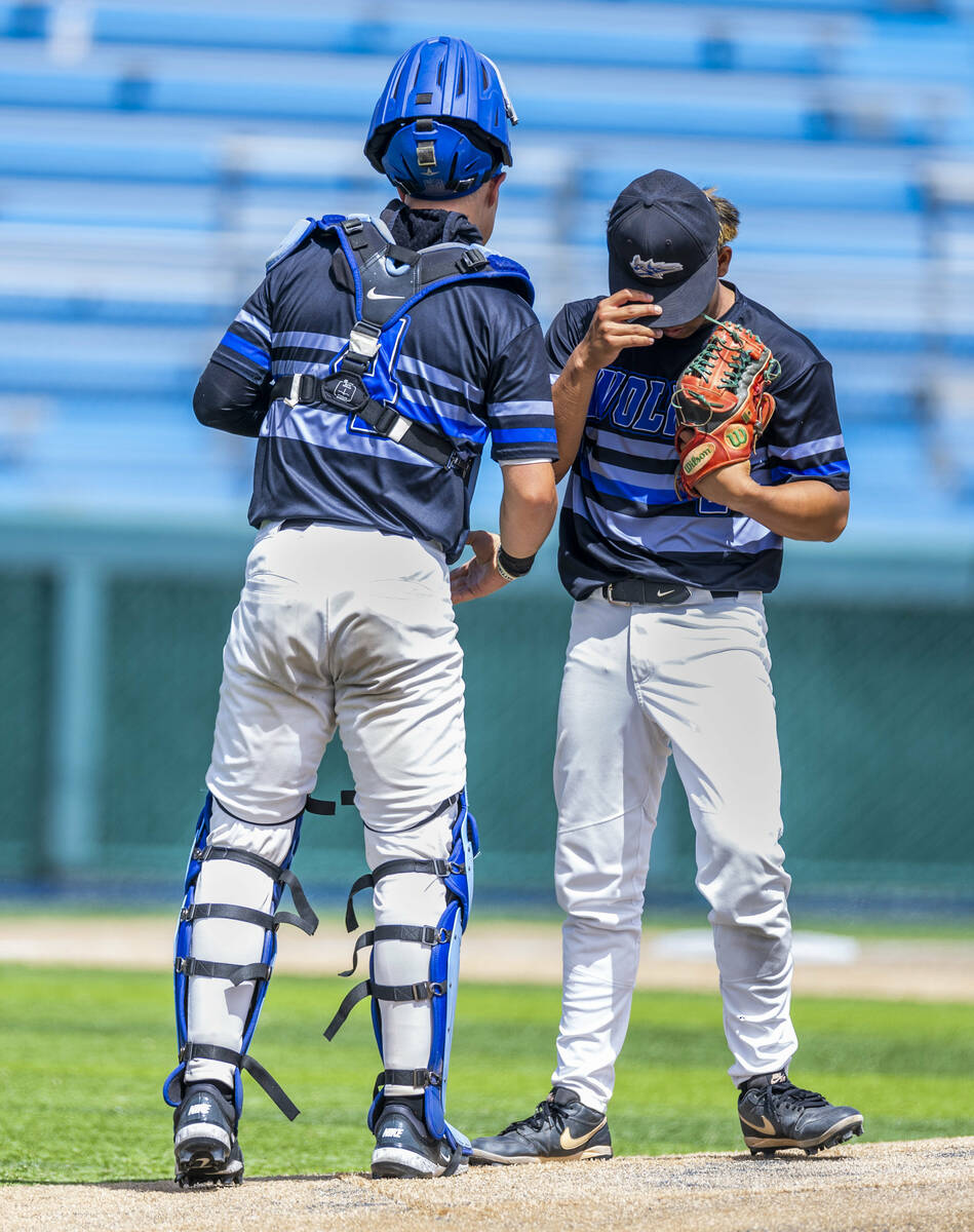 Basic catcher Koa Won (4) helps his pitcher Troy Southisene (2) get focused on the mound during ...